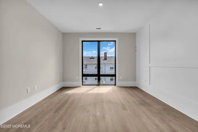 a large bedroom with a bed and wooden floor