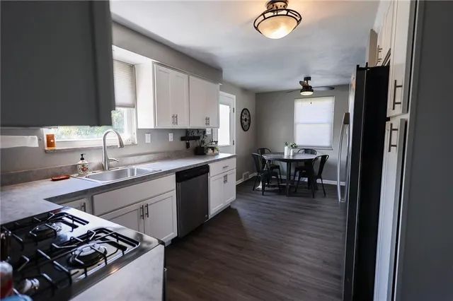 a kitchen with a sink stove and cabinets