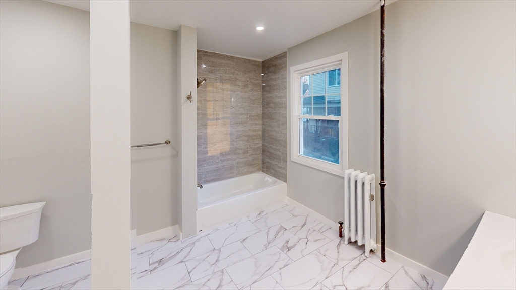 168 Oak Street, Unit 1 Gardner, MA 01440 - Photo 11 of 23 a bathroom with a bathtub and a shower