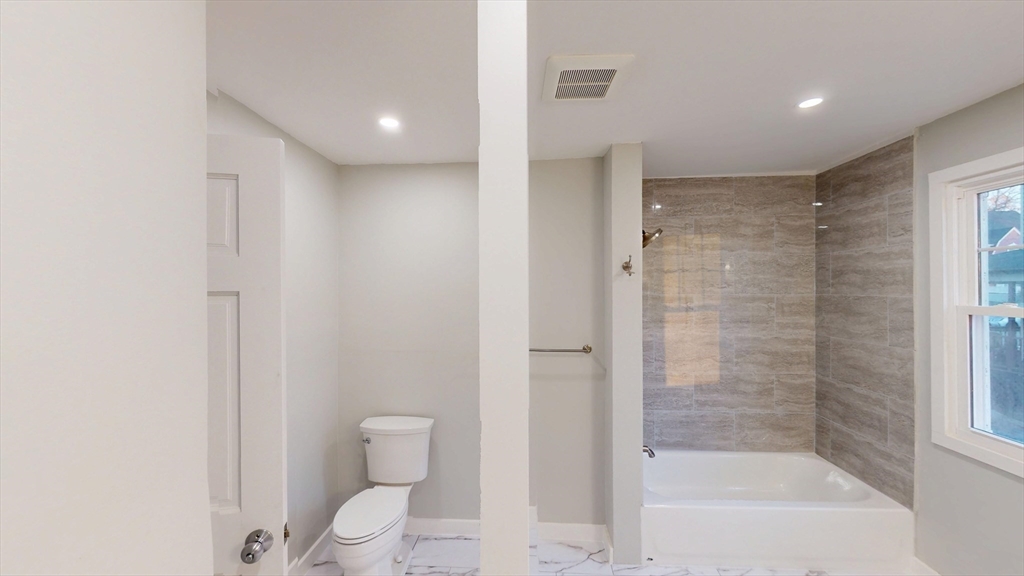 168 Oak Street, Unit 1 Gardner, MA 01440 - Photo 12 of 23 a bathroom with a bathtub and a toilet