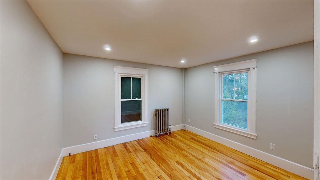 168 Oak Street, Unit 1 Gardner, MA 01440 - Photo 15 of 23 a view of an empty room with wooden floor and a window