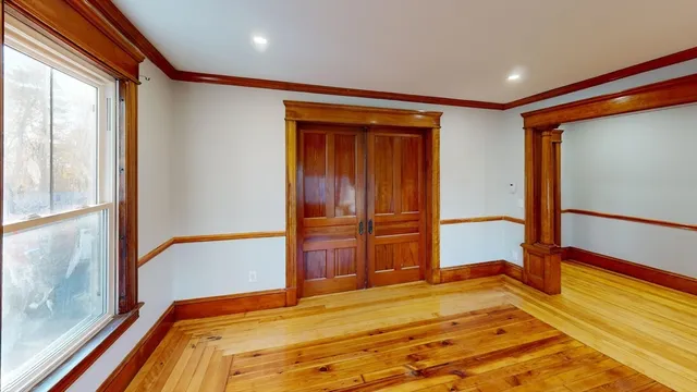 a bedroom with a bed and a large window