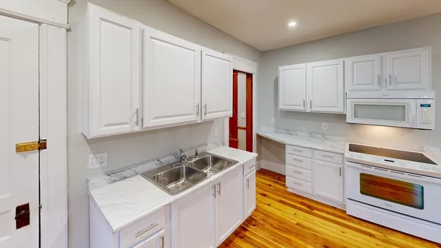 a kitchen with a sink cabinets and appliances