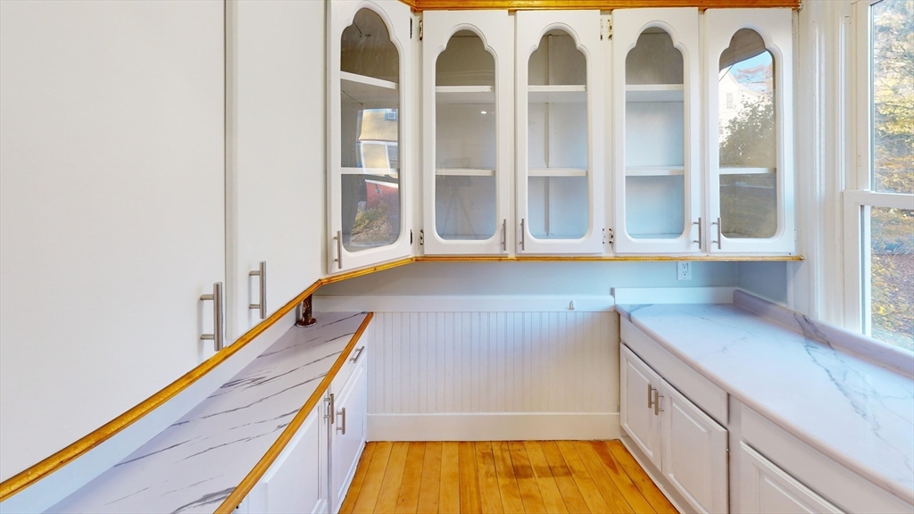 168 Oak Street, Unit 1 Gardner, MA 01440 - Photo 6 of 23 a view of an empty room with wooden floor and windows