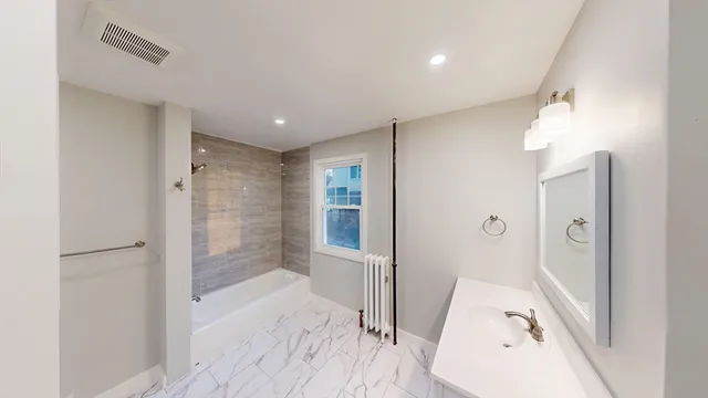 a bathroom with a bathtub and a shower
