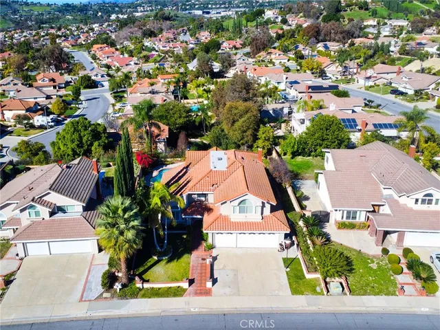 an aerial view of a house with a yard and garden