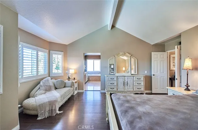 a bathroom with a granite countertop tub shower and mirror