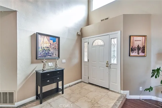 a living room with furniture a wooden floor and a large window