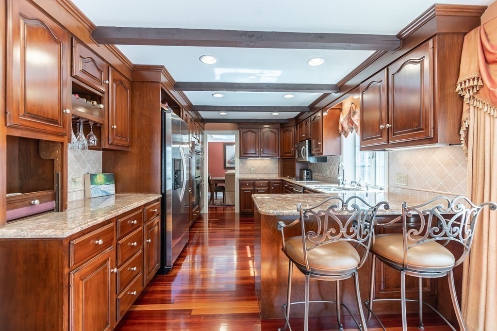 83 Valley Road Boxford, MA 01921 - Photo 12 of 31 a kitchen with stainless steel appliances granite countertop a stove a sink and a refrigerator