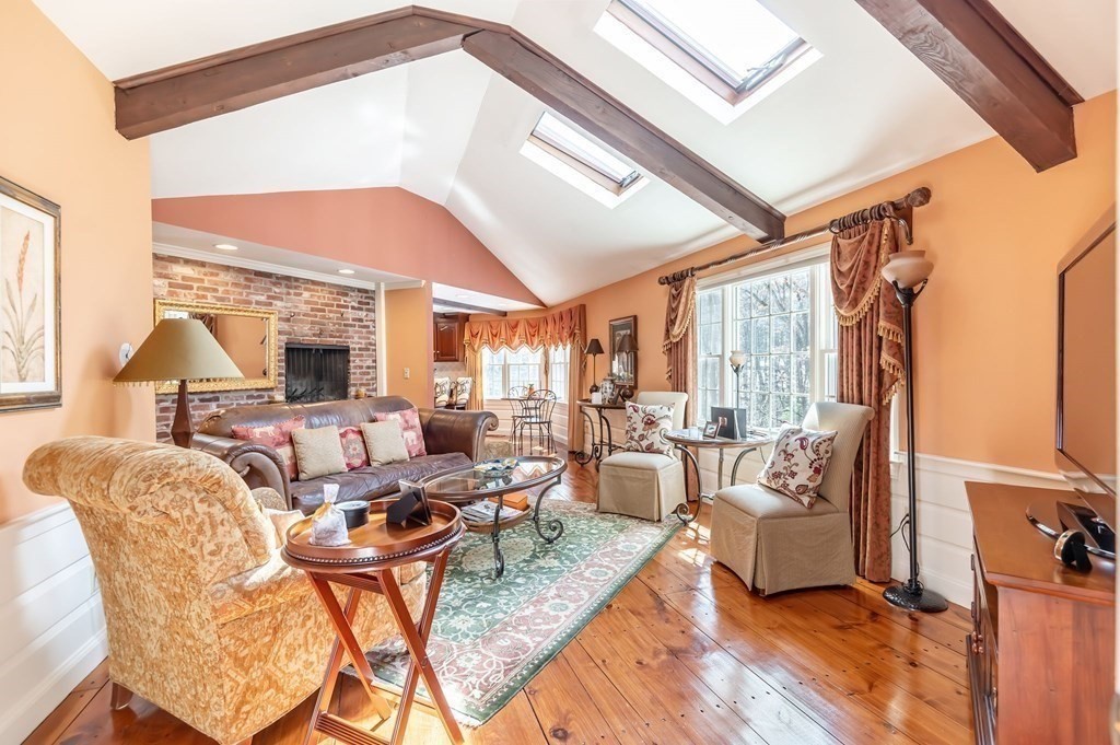 83 Valley Road Boxford, MA 01921 - Photo 9 of 31 a living room with fireplace furniture and a large window