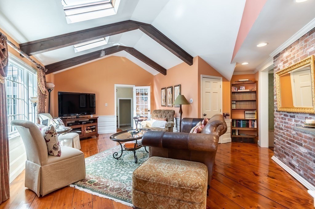 83 Valley Road Boxford, MA 01921 - Photo 10 of 31 a living room with furniture fireplace and a flat screen tv