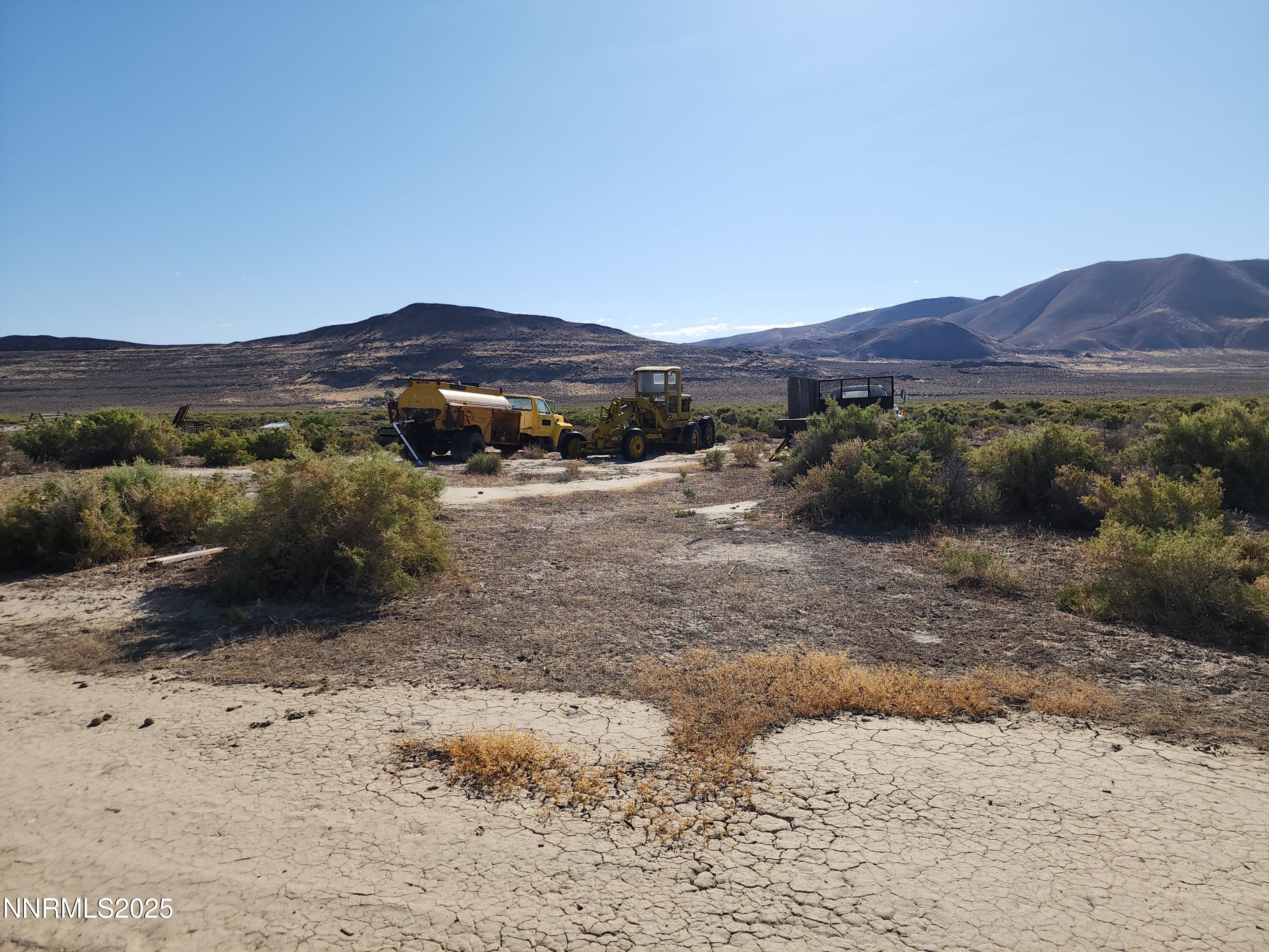 1385 Rancho Lane, Unit OUT IN HONEY LAKE BASIN ON NV SIDE Reno, NV 89510 - Photo 40 of 47 a view of a dry yard with mountains in the background