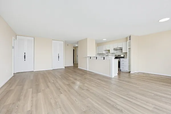 a view of a kitchen with a sink and a refrigerator