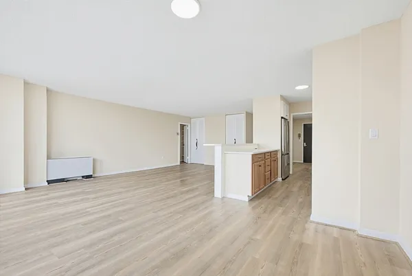 a view of a kitchen with wooden floor and a sink