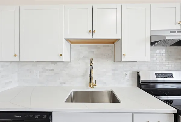 a kitchen with a sink and cabinets
