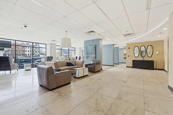 a living room with furniture and a chandelier