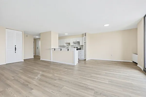 a view of a kitchen with a sink and a refrigerator