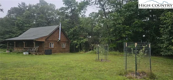 a house view with a play ground in front of it