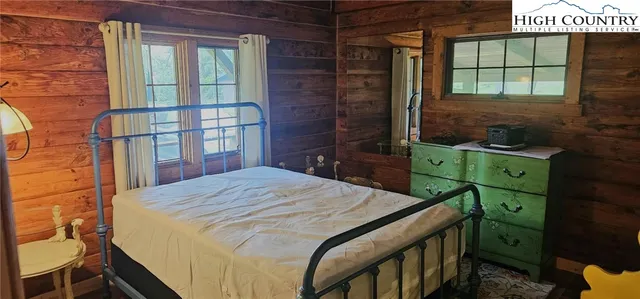 a bedroom with a bed dresser and a window