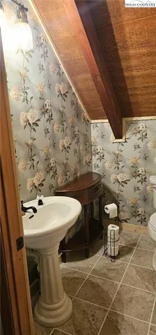 a bathroom with a sink toilet and mirror