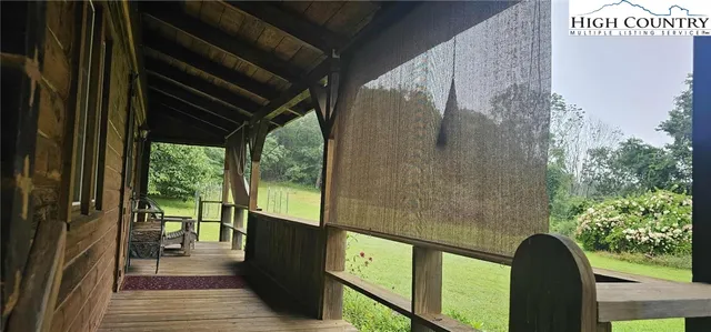 a view of a balcony with wooden floor and furniture
