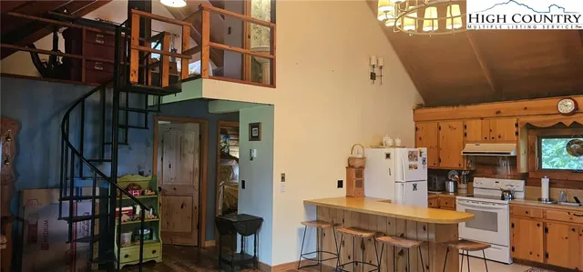 a view of dinning table and chairs in a room