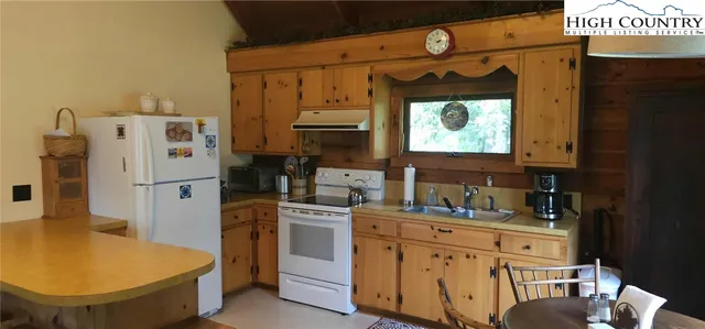 a kitchen with stainless steel appliances a refrigerator sink and cabinets