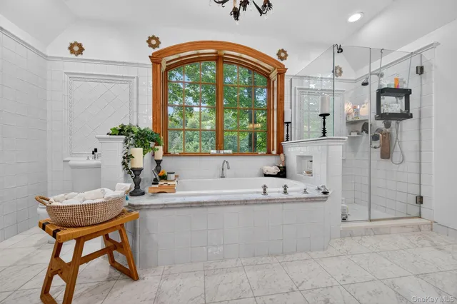 a bathroom with a tub sink and mirror