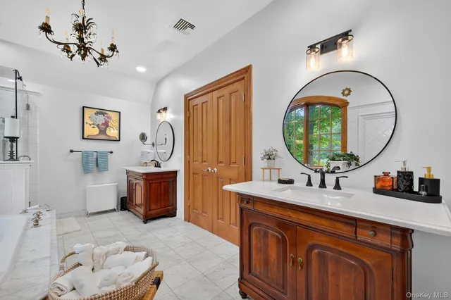 a bathroom with a sink a mirror and a bathtub