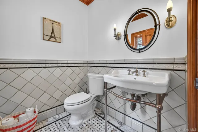 a bathroom with a sink a toilet and a mirror