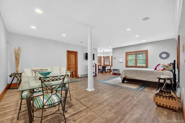 a living room with furniture a air conditioner and a window