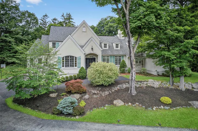 a view of a house with a backyard and a tree