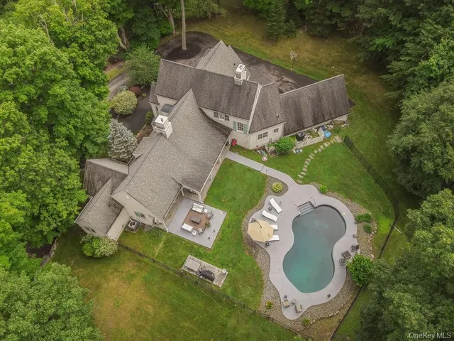 an aerial view of a house with garden space and street view