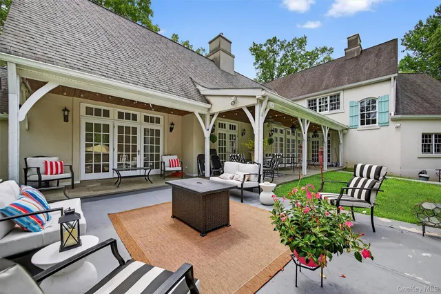 a view of a patio with table and chairs and potted plants