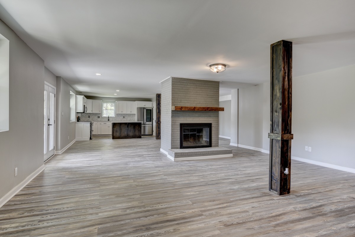 401 S Road Cottontown, TN 37048 - Photo 12 of 50 a view of empty room with wooden floor and fireplace
