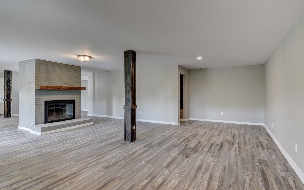 401 S Road Cottontown, TN 37048 - Photo 13 of 50 a view of empty room with wooden floor and fireplace