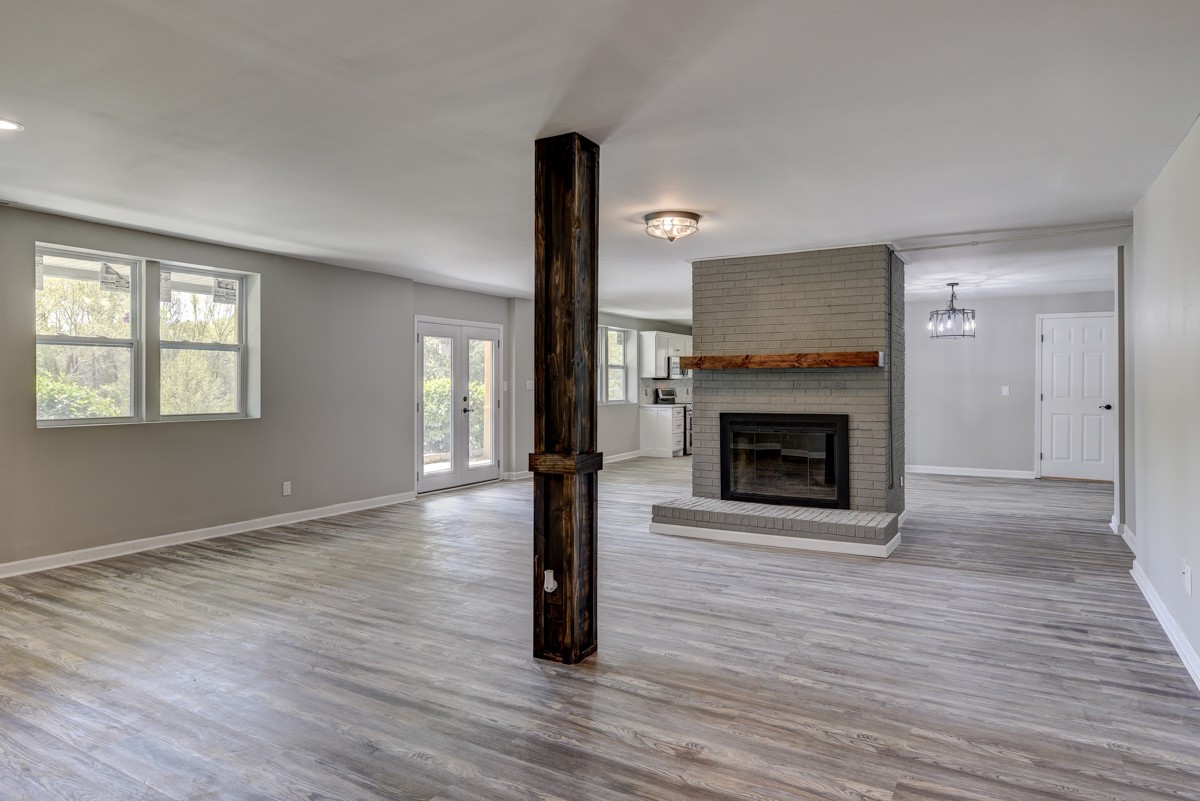 401 S Road Cottontown, TN 37048 - Photo 14 of 50 a view of an empty room with wooden floor fireplace and a window
