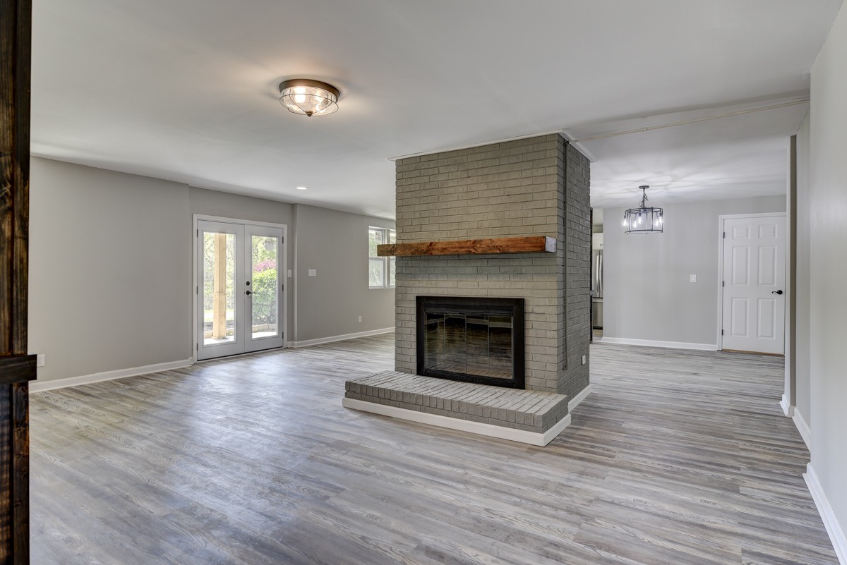 401 S Road Cottontown, TN 37048 - Photo 15 of 50 a view of an empty room with wooden floor fireplace and a window