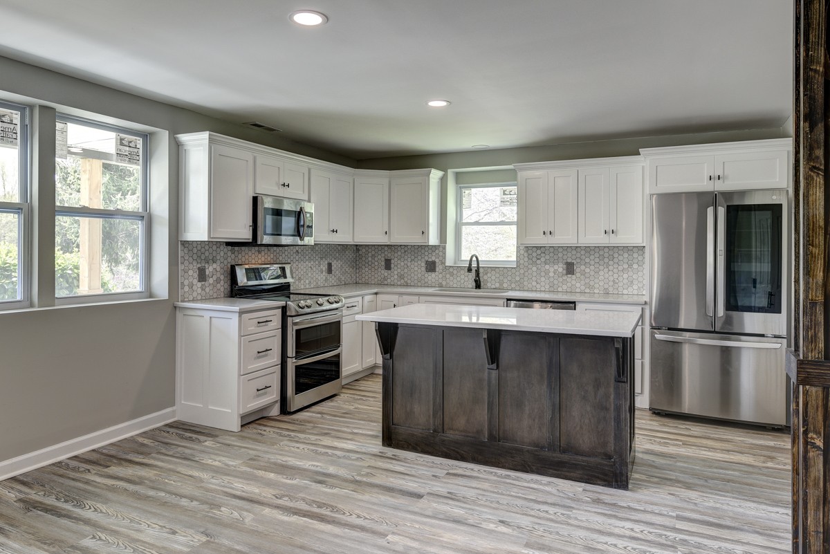 401 S Road Cottontown, TN 37048 - Photo 18 of 50 a kitchen with stainless steel appliances granite countertop a stove a sink and a refrigerator