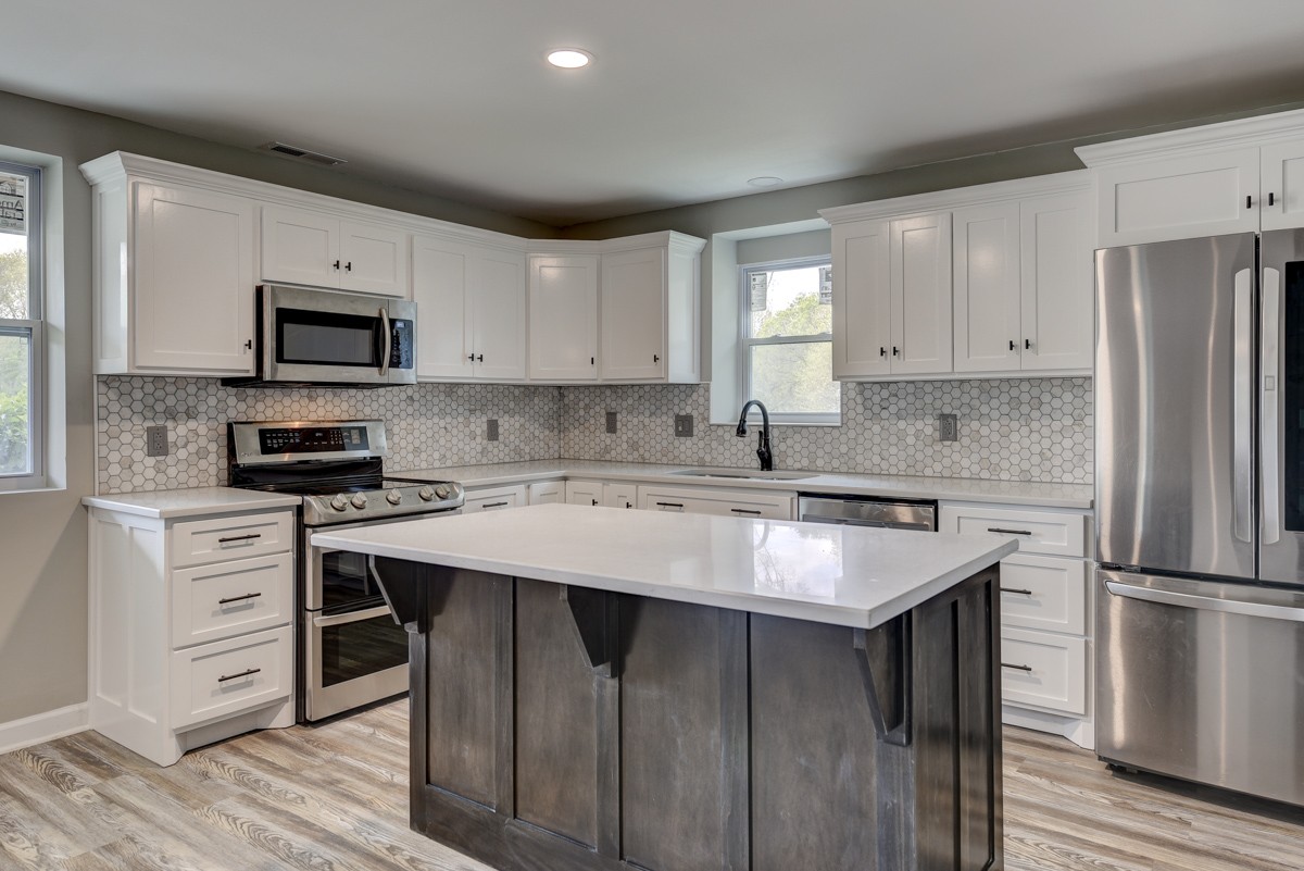 401 S Road Cottontown, TN 37048 - Photo 19 of 50 a kitchen with a stove a sink and a refrigerator
