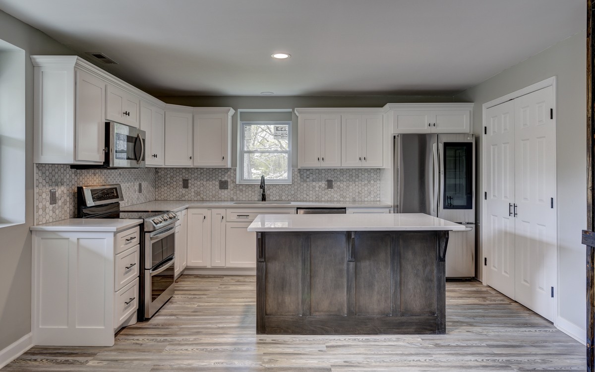 401 S Road Cottontown, TN 37048 - Photo 20 of 50 a kitchen with stainless steel appliances sink cabinets and wooden floor