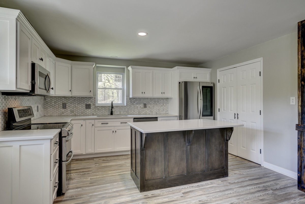 401 S Road Cottontown, TN 37048 - Photo 21 of 50 a kitchen with wooden cabinets sink and stove