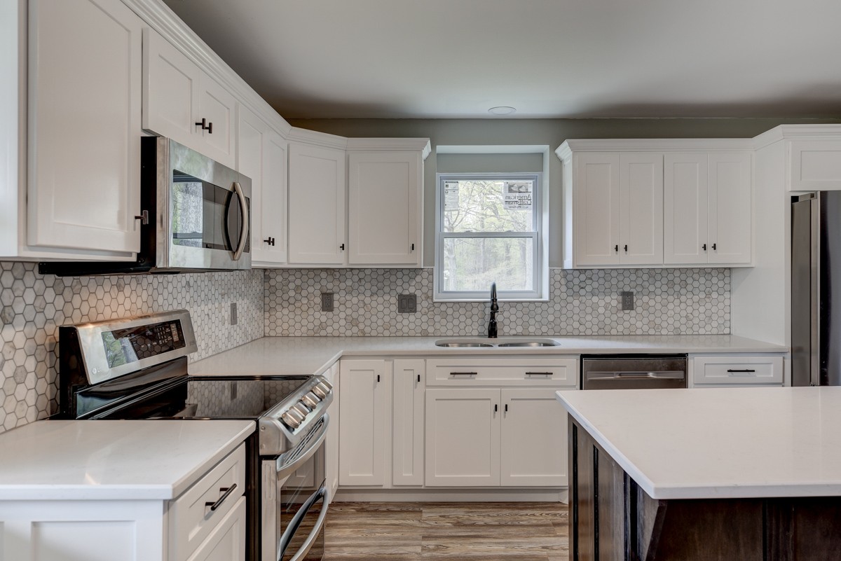401 S Road Cottontown, TN 37048 - Photo 22 of 50 a kitchen with stainless steel appliances granite countertop a stove top oven a sink a counter space and cabinets