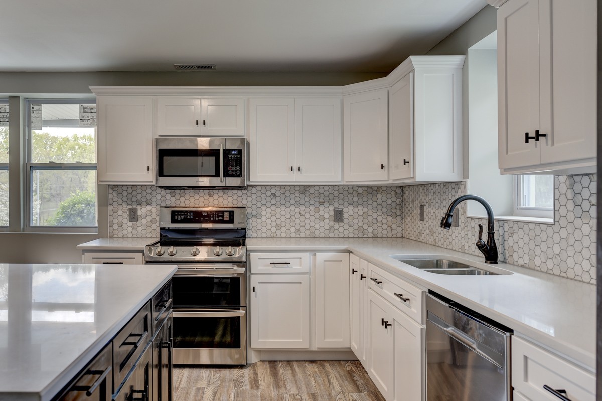 401 S Road Cottontown, TN 37048 - Photo 23 of 50 a kitchen with stainless steel appliances white cabinets a sink and a stove