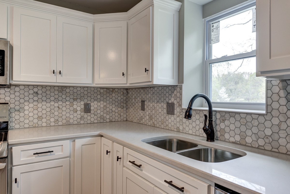 401 S Road Cottontown, TN 37048 - Photo 24 of 50 a kitchen with white cabinets and a sink