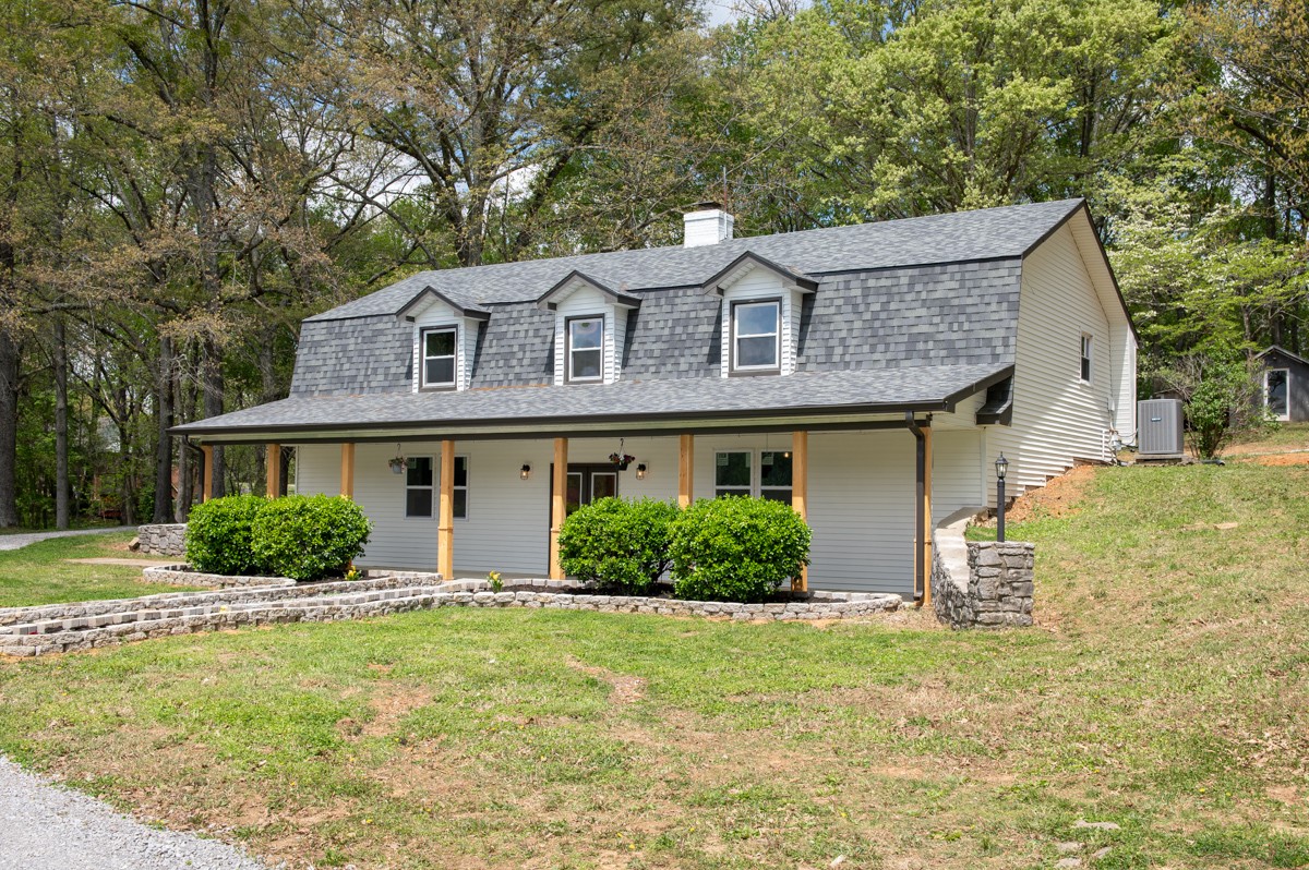 401 S Road Cottontown, TN 37048 - Photo 4 of 50 a front view of a house with a yard and garage