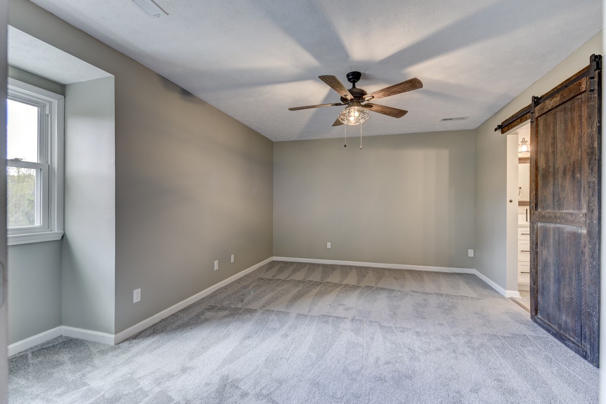 401 S Road Cottontown, TN 37048 - Photo 31 of 50 an empty room with windows and fan
