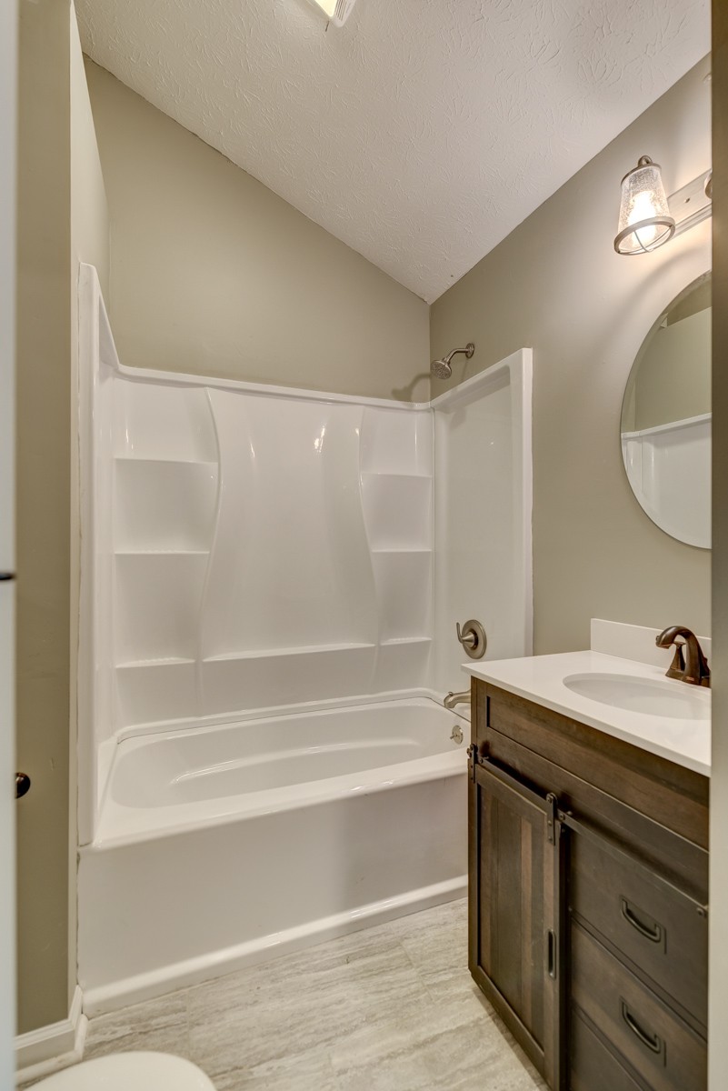 401 S Road Cottontown, TN 37048 - Photo 43 of 50 a bathroom with a sink mirror vanity and a bathtub