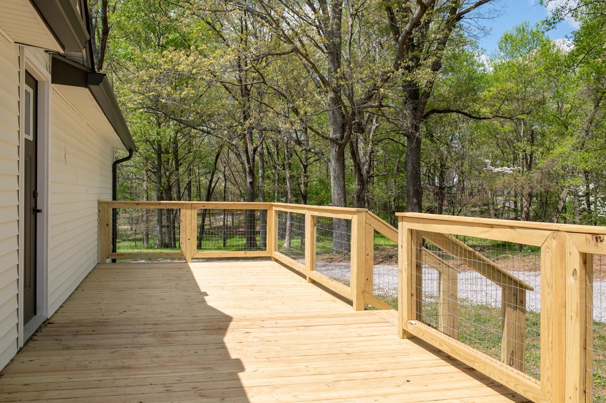 401 S Road Cottontown, TN 37048 - Photo 47 of 50 a view of a balcony with wooden floor and fence