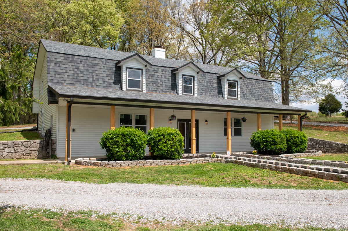 401 S Road Cottontown, TN 37048 - Photo 8 of 50 a front view of a house with a yard and garage